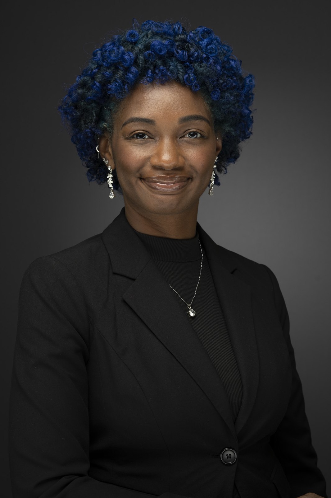 A warm, individual studio portrait from a consistent company headshot series